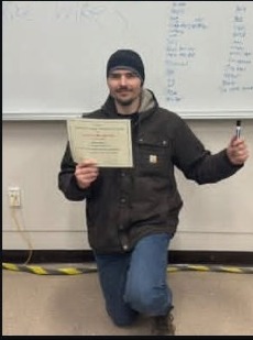 Michael holding a certificate at a family milestone